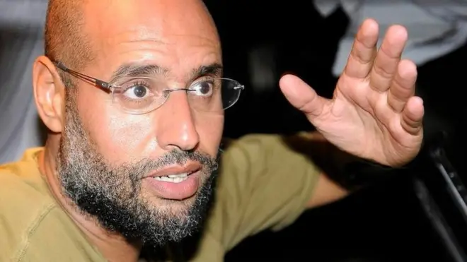 Saif Al-Islam, son of Libyan leader Muammar Gaddafi, gestures as he talks to reporters in Tripoli August 23, 2011