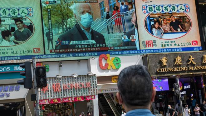 Democratic Party presidential candidate Joe Biden appears on a television screen during a news report about the US elections, in Hong Kong, China, 04 November 2020.