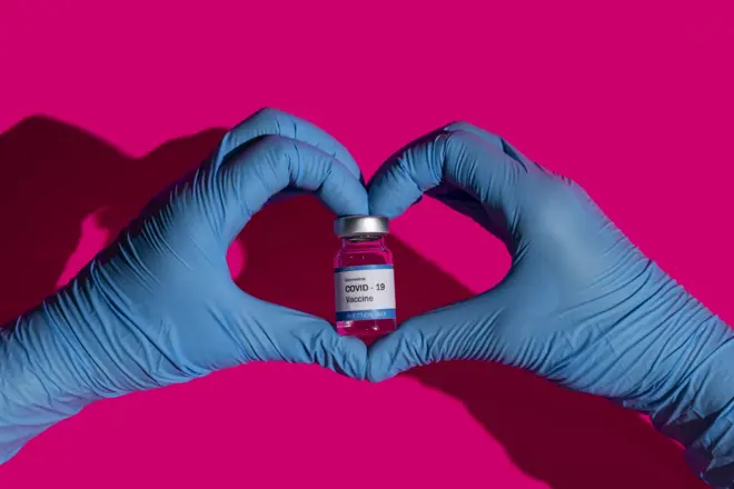vaccine vial hands heart