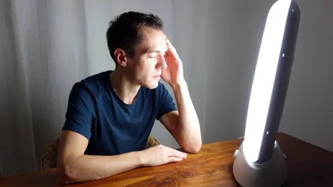 Man in front of a light box