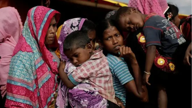 Rohingya refugees line up for a food supply distribution at the Kutupalong refugee camp near Cox's Bazar, Bangladesh 12 December 2017.
