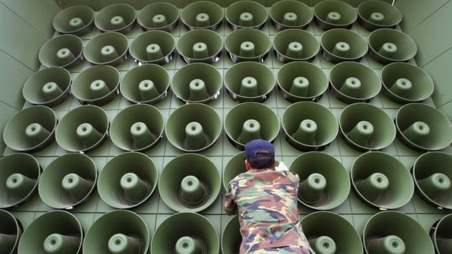 A South Korean soldier takes down a battery of propaganda loudspeakers on the border with North Korea in Paju on 16 June 2004
