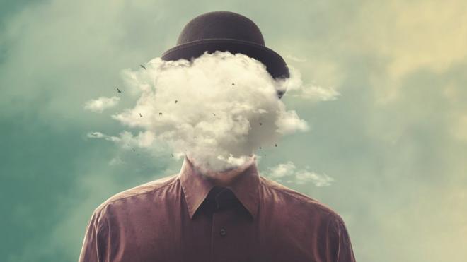 A surreal picture of a man in a bowler hat with a big white cloud instead of his head