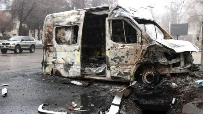 A burnt minibus pictured in a street in Kazakhstan's main city, Almaty