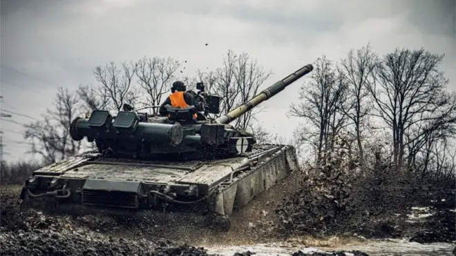 A service member of the Ukrainian Naval Infantry Corps (Marine Corps) rides a tank during drills at a training ground in an unknown location in Ukraine, in this handout picture released February 18, 2022.
