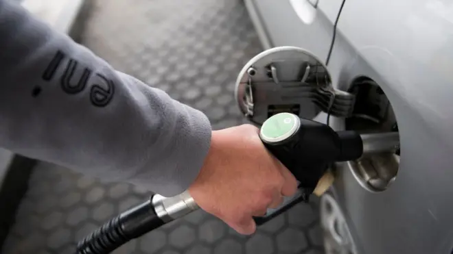 Man refueling a car with gasoline