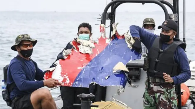 Sejumlah prajurit Detasemen Jala Mangkara (Denjaka) Korps Marinir TNI AL mengangkut serpihan dari pesawat Sriwijaya Air SJ 182 yang hilang kontak saat melakukan pencarian di perairan Kepulauan Seribu, Jakarta, Minggu (10/1/2021).