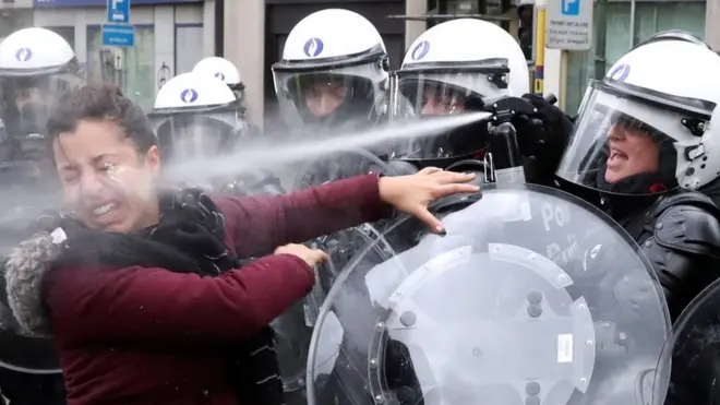 A woman is sprayed with tear gas by a riot police officer during a 'yellow vests' protest against higher fuel prices, in Brussels, Belgium, in December. Reuters photographer Yves Herman said of the woman: "When one young man was seized, a young woman with him rushed towards the line of police, shouting that he had done nothing wrong ... She wasn't even wearing one of the fluorescent yellow vests."