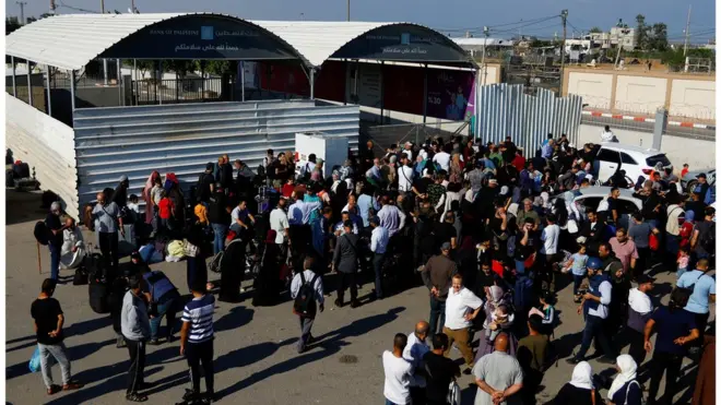 Palestinians gather outside the Rafah border crossing with Egypt