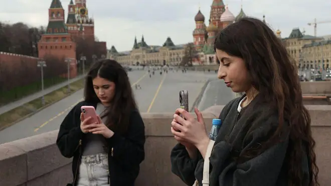 इंटरनेट एक्सेस करने की कोशिश करतीं क्रेमलिन के क़रीब खड़ी महिलाएं (सांकेतिक तस्वीर)