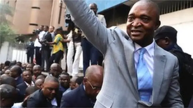Former Congolese interior minister Emmanuel Ramazani Shadary waves to his supporters as he arrives to file his candidacy for the presidential election, at the Congo"s electoral commission (CENI) head offices at the Gombe Municipality in Kinshasa, Democratic Republic of Congo, August 8, 2018.
