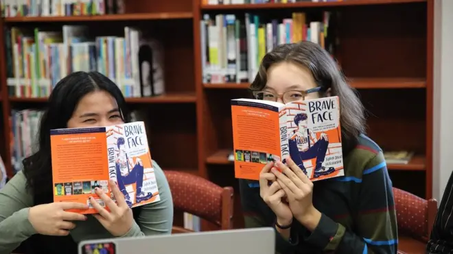 Two girls posing with banned books