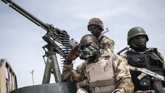 Three soldiers wey siddon on top tanker.