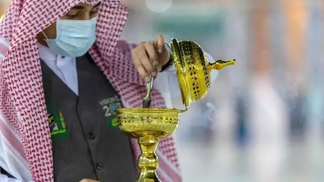 A handout picture provided by the Saudi ministry of media shows a member of the hajj staff burning incense at the Grand Mosque in the holy city of Mecca on 26 July 2020