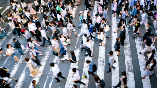 A crowd rushing past