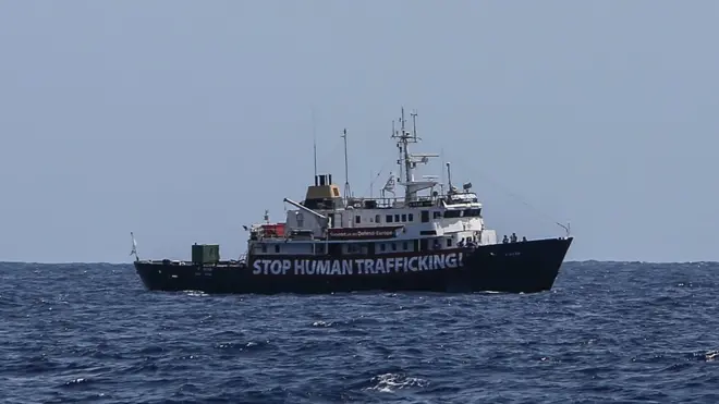 Dis photo from August 13, 2017 dey show banner wey say 'Stop Human Trafficking' e dey for di Mediterranean Sea, part of where dem dey carry migrants wey dey try enter Europe illegally.