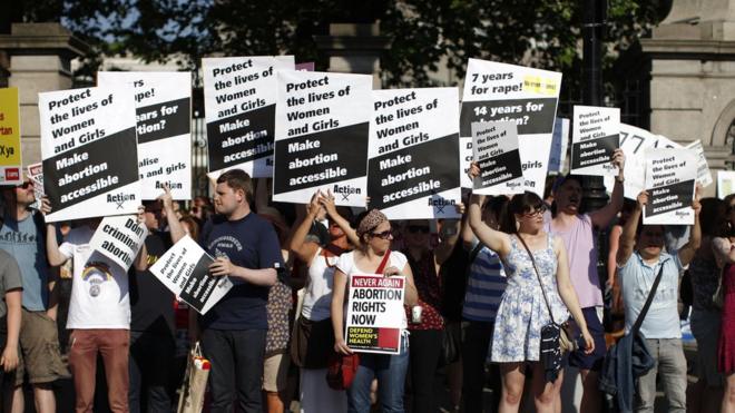 Pro-Choice supporters hold placards in front of the gates of the Irish Parliament building in Dublin on 10 July 2013 during a demonstration ahead of a vote to introduce abortion in limited cases where the mother's life is at risk.