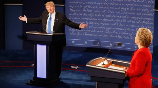 Republican presidential nominee Donald Trump (L) speaks as Democratic presidential nominee Hillary Clinton (R) listens during the Presidential Debate at Hofstra University in New York.