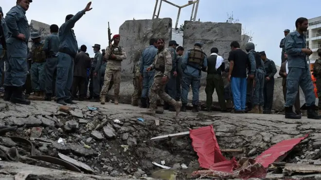 Afghan security personnel stand at the scene of a suicide attack by Taliban militants on the Afghan parliament building in Kabul on June 22, 2015.