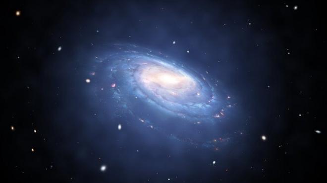 Artist's impression of a spiral galaxy with blue arms of dust and stars. A blue glow surrounds it.