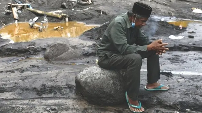 Musmin, 55, mengunjungi sebuah lokasi yang dia yakini sebagai tempat cucunya terkubur materi vulkanis Gunung Semeru.