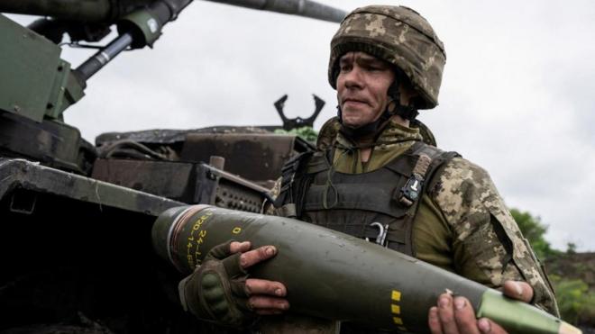 A Ukrainian service member of the 55th Separate Artillery Brigade prepare carries a shell for a Caesar self-propelled howitzer before firing towards Russian troops, amid Russia's attack on Ukraine, near the town of Avdiivka in Donetsk region (file pic)