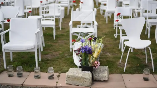 An art installation featuring 185 empty chairs on display in the Botanical Gardens in Christchurch, New Zealand