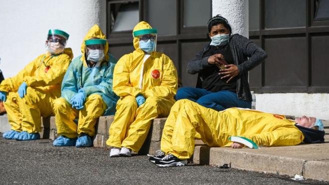 Health care professionals take a break awaiting patients as they test for COVID-19 at the ProHEALTH testing site in Jericho, New York, March 24, 2020.