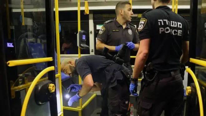 Israeli security inspect a bus after an attack outside Jerusalem's Old City, August 14, 2022.