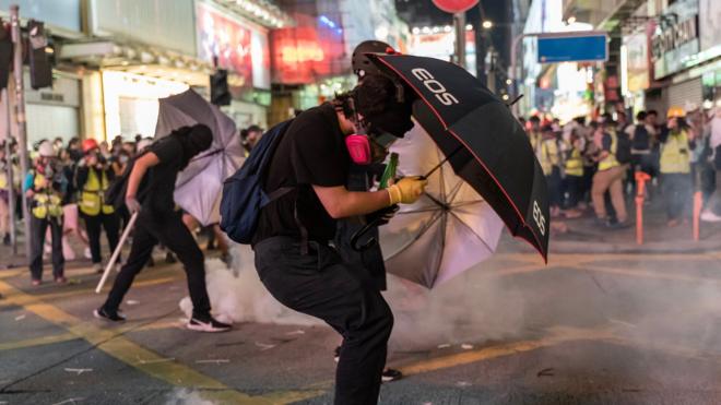 Pro-democracy protesters react as police fire tear gas during a demonstration on October 20, 2019 in Hong Kong, China