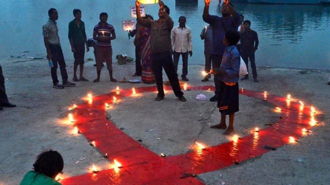 人们在世界艾滋病日当天点燃蜡烛