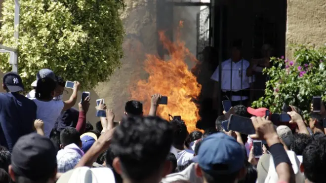 A host of mobile phones are raised aloft to capture the moment Ricardo and Alberto Flores died