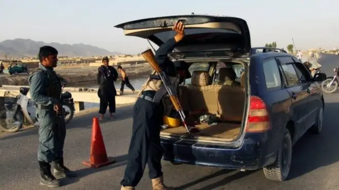 Police conduct a vehicle search in Kandahar after the reported kidnapping