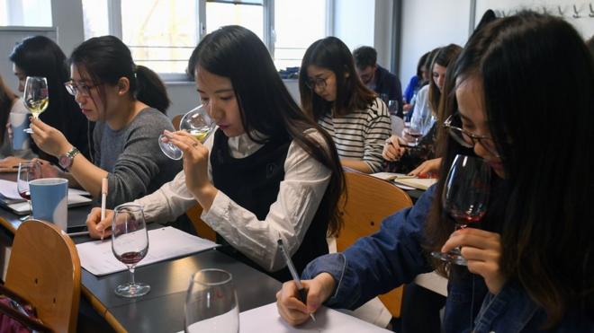 Chinese students taste and study wine during a class on March 16, 2017 at the School of Wine of the Dijon Business School.