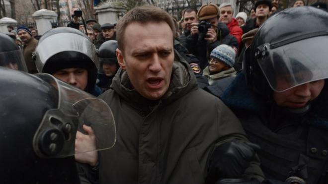 Police officers detain protest leader Alexei Navalny outside Zamoskvoretsky district court in Moscow, on 24 February 2014