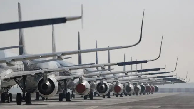 Passenger planes parked on a runway on 26 May