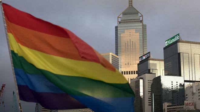 A rainbow flag, a symbol of the Lesbian, Gay, Bi-sexual and Transgender (LGBT) community is seen in front of the city skyline in Hong Kong on November 6, 2015.