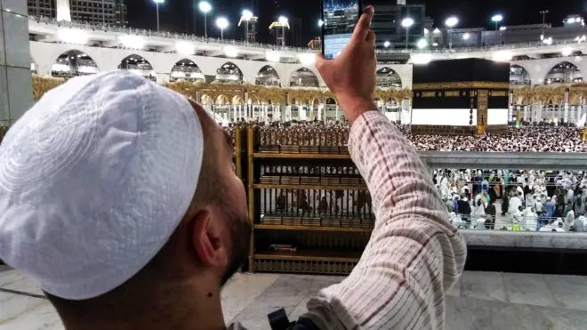 A Muslim worshipper uses his cell phone to livestream film others circumambulating around the Kaaba, Islam's holiest shrine, at the Grand Mosque in Saudi Arabia's holy city of Mecca on August 17, 2018 prior to the start of the annual Hajj pilgrimage in the holy city.