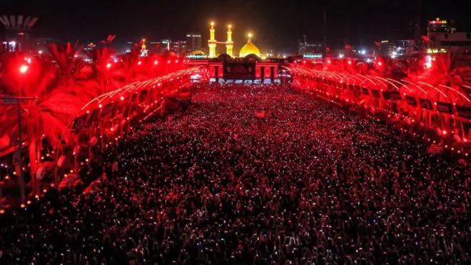 Muslim devotees gather during the flag-changing ceremony at the shrines of Imam Hussein and Imam Abbas in Iraq's central shrine city of Karbala on July 18, 2023