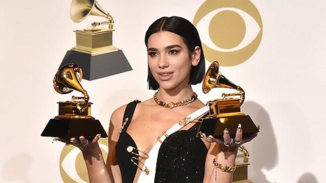 Dua Lipa holds trophies at the 2019 Grammy Awards