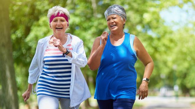 Dos mujeres de edad madura haciendo ejercicio en un parque
