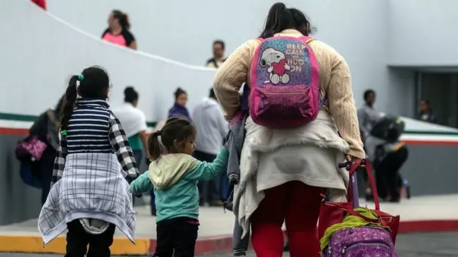 Migrants walk towards El Chaparral port of entry in Tijuana, Mexico, in the border with the US