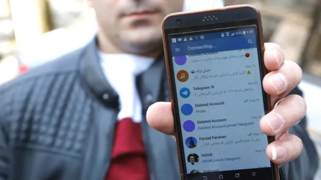 An Iranian man shows his social media page which doesn"t work in a street in Tehran, Iran, 02 January 2018