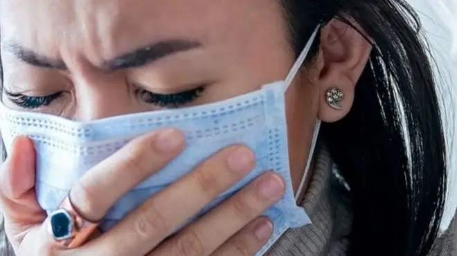 Mulher de máscara doente