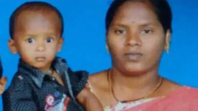 Sujith on his mother's arm with his brother and father