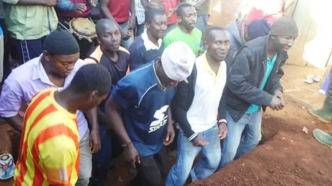 Young boy den di mash ground for bury queen mother