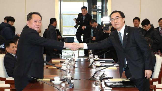South Korean Unification Minister and chief delegate Cho Myoung-gyon (R) shakes hands with his North Korean counterpart Ri Son-gwon