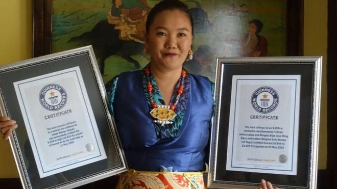 Lhakpa Sherpa holding Guinness World Record certificates in frames