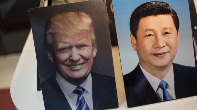 Framed photographs of Chinese President Xi Jinping (R) and US President Donald Trump are seen on display in a photo shop in Beijing on November 6, 2017. Donald Trump arrives in China on November 8, which is the third stop of his tour in Asia. / AFP PHOTO / FRED DUFOURFRED DUFOUR/AFP/Getty Images