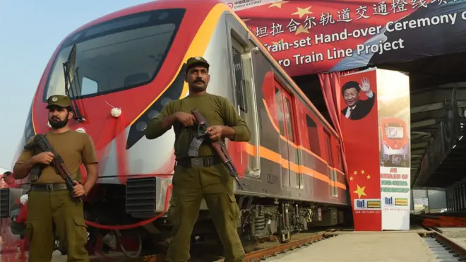 Pakistani policemen stand guard during the unveiling ceremony of the first set of carriages of Lahore Orange Line MetroTrain in Lahore on October 8, 2017.